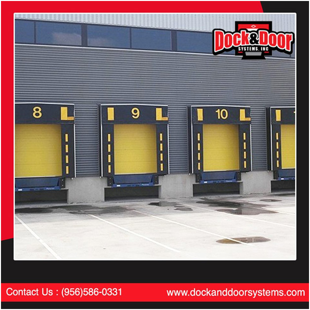Row of numbered loading dock doors with dock levelers on a warehouse exterior