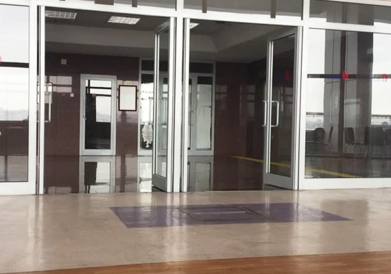 Row of glass entrance doors in a building lobby