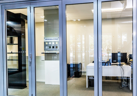 Aluminum-framed glass entry doors at a commercial office
