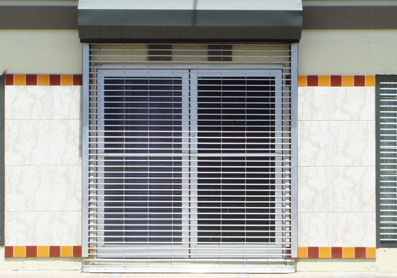 Rolling security grille over a storefront entrance