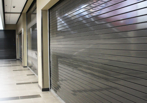 Row of coiling fire doors along an interior corridor