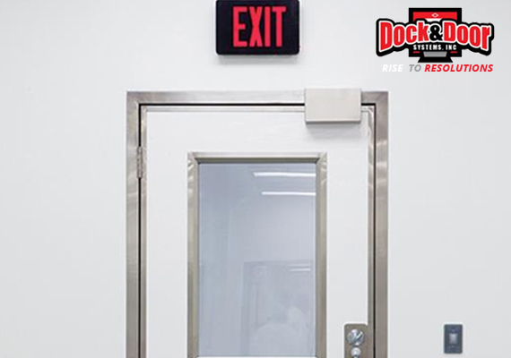 Stainless-steel-framed swinging door with a window below an exit sign