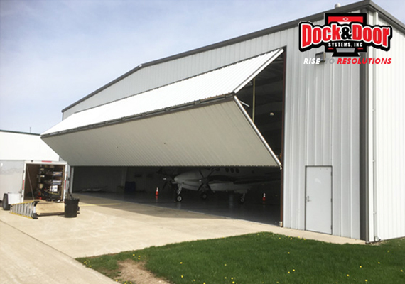 Large hydraulic hangar door open on an aircraft hangar