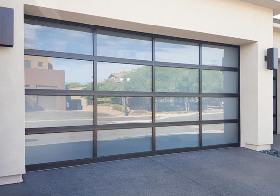 Full-view glass garage-style sectional door on a building exterior