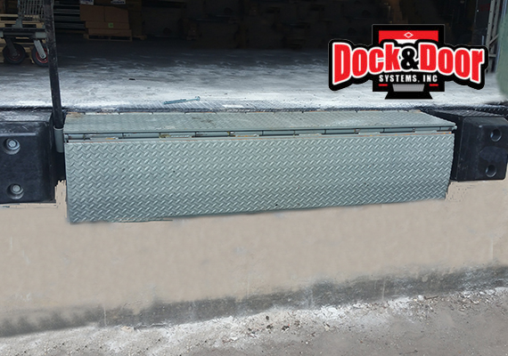 Edge-of-dock leveler lip extended at a loading dock opening