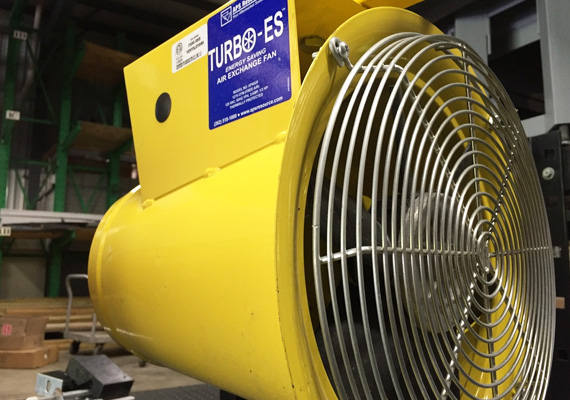 Industrial air exchange fan mounted in a warehouse