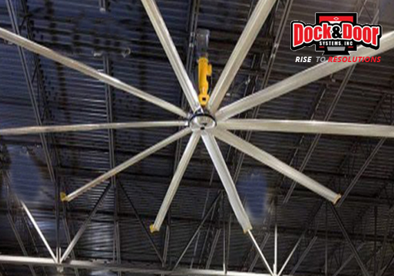 Large HVLS ceiling fan mounted in a warehouse roof structure