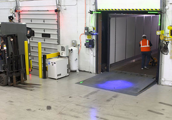 Loading dock with a light communication system mounted above a door opening