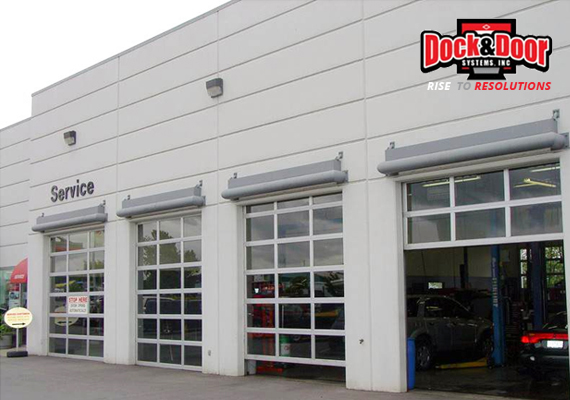 Full-view glass service doors on an auto service center building