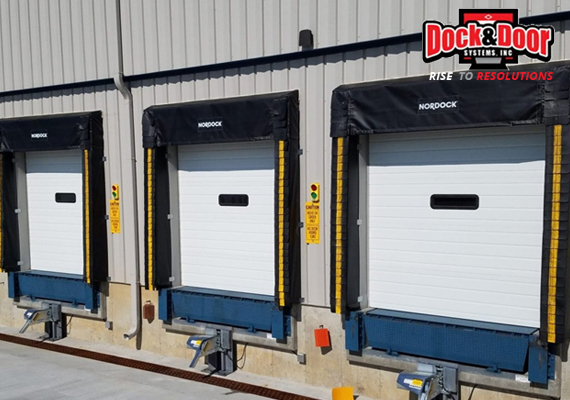 Three loading dock doors with dock seals and edge-of-dock levelers