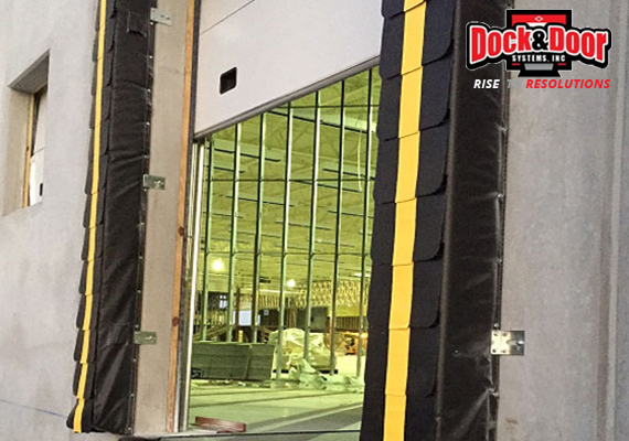 High-speed fabric roll-up door open at a warehouse loading dock