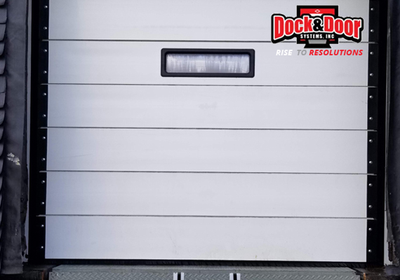 Closed sectional dock door with a small viewing window