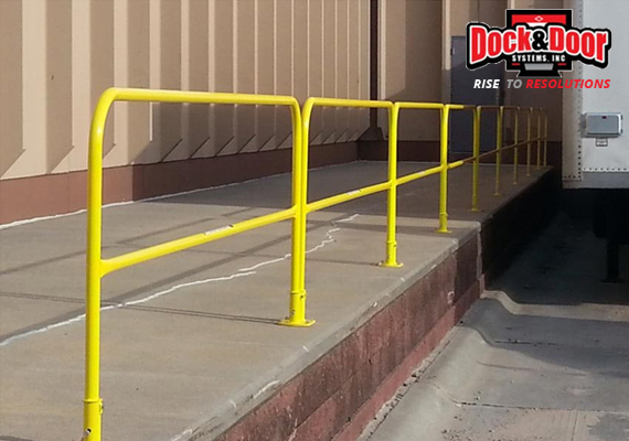 Yellow safety guardrail along a raised loading dock platform edge