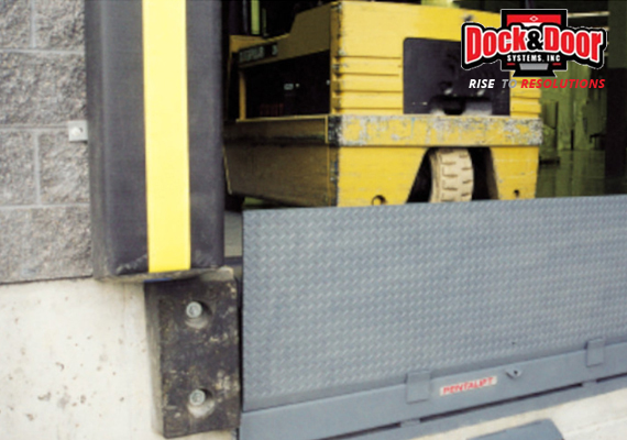 Dock leveler lip extended at a loading dock opening with a forklift approaching